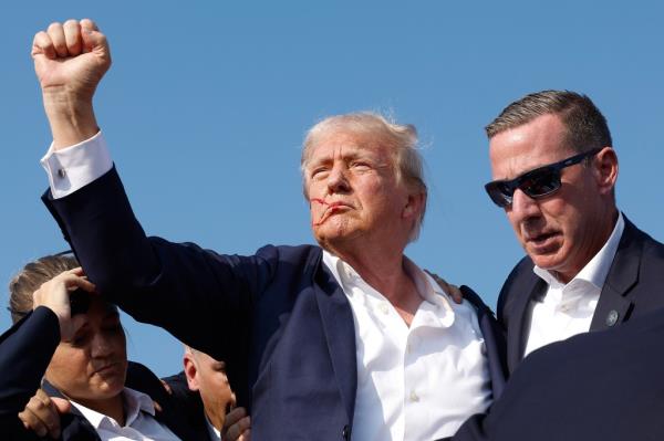 Donald Trump pumps his fist in defiance after surviving an assassination attempt last month.