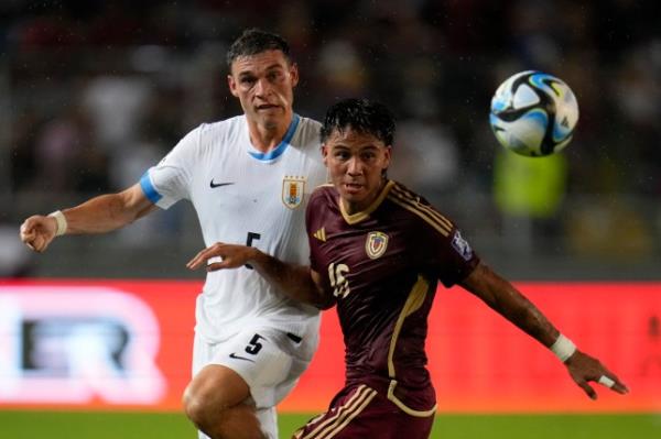 Uruguay's Manuel Ugarte, left, chases Venezuela's Telasco Segovia during a qualifying soccer match for the FIFA World Cup 2026 at Monumental de Maturin Stadium in Maturin, Venezuela
